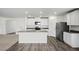 Well-lit kitchen with stainless steel appliances, white cabinetry, and a central island with bar seating at 1720 Sandia Rock Ave, North Las Vegas, NV 89032