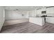Open concept living and kitchen area featuring vinyl flooring and white kitchen cabinetry at 1720 Sandia Rock Ave, North Las Vegas, NV 89032