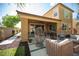 Back patio with outdoor seating, fire pit and manicured yard at 2198 Maderno St, Henderson, NV 89044