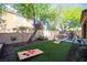 Green backyard with artificial turf, cornhole game and outdoor seating at 2198 Maderno St, Henderson, NV 89044