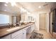 Bright bathroom with double sinks, vanity, sleek cabinets, and a glass shower at 2198 Maderno St, Henderson, NV 89044