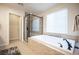 Well-lit bathroom featuring a soaking tub and a separate glass-enclosed shower at 2198 Maderno St, Henderson, NV 89044