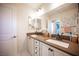 Bathroom featuring a double sink vanity with granite countertops and white cabinets at 2198 Maderno St, Henderson, NV 89044