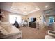 Comfortable bedroom with a decorative tray ceiling, plush carpet, and ample natural light at 2198 Maderno St, Henderson, NV 89044
