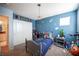 Blue bedroom with a closet, star accents and comic decorations at 2198 Maderno St, Henderson, NV 89044