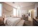 Bedroom featuring white bedding, mirrored vanity and chandelier at 2198 Maderno St, Henderson, NV 89044