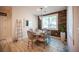 Dining area featuring a decorative wood accent wall, chandelier, and large window at 2198 Maderno St, Henderson, NV 89044