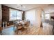 Dining room with wood accent wall, chandelier, and a view into the living room at 2198 Maderno St, Henderson, NV 89044