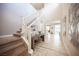 Spacious entryway with tiled floors, decorative wall art, staircase and view of the living spaces beyond at 2198 Maderno St, Henderson, NV 89044