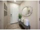 Home entryway with a bench, decorated mirror and wall decor, complemented by tile floors at 2198 Maderno St, Henderson, NV 89044