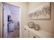 Hallway featuring unique artwork, storage cabinets and an entry into a bedroom at 2198 Maderno St, Henderson, NV 89044