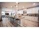 Modern kitchen with granite countertops, stainless steel appliances, island seating, and an open floor plan at 2198 Maderno St, Henderson, NV 89044