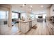 Open-concept kitchen with island seating, granite countertops, stainless steel appliances, and an open floor plan at 2198 Maderno St, Henderson, NV 89044