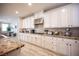 Well-lit kitchen featuring granite countertops, stainless steel appliances, and sleek white cabinetry at 2198 Maderno St, Henderson, NV 89044