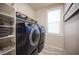 Laundry room with blue washer and dryer and white shelving at 2198 Maderno St, Henderson, NV 89044