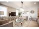 Contemporary living room featuring a glass coffee table, modern decor, chandelier, and tiled floors at 2198 Maderno St, Henderson, NV 89044
