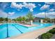 Beautiful community pool with lounge chairs, clear blue water, and sunny skies at 2198 Maderno St, Henderson, NV 89044