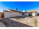 Private backyard with a stone-paved patio, white gravel accents, and mature trees at 2368 Winterwood Blvd, Las Vegas, NV 89142
