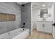 Modern bathroom featuring a gray-tiled shower-tub and white vanity with matte black fixtures at 2368 Winterwood Blvd, Las Vegas, NV 89142