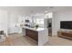 Modern kitchen features white cabinetry, stainless steel appliances, and a large center island with counter seating at 2368 Winterwood Blvd, Las Vegas, NV 89142