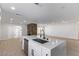 Modern kitchen featuring an island with stainless steel appliances and a sink at 2368 Winterwood Blvd, Las Vegas, NV 89142