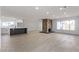 Spacious living room with a stone fireplace and an open floor plan to the modern kitchen at 2368 Winterwood Blvd, Las Vegas, NV 89142