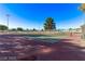 Outdoor tennis courts with red and green playing surface and surrounded by mature trees at 2368 Winterwood Blvd, Las Vegas, NV 89142