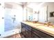 Modern bathroom boasts walk-in shower, dual sinks, and elegant fixtures at 2539 Turtle Head Peak Dr, Las Vegas, NV 89135