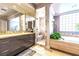 Modern bathroom featuring a glass-enclosed shower, a soaking tub, and stylish vanities at 2539 Turtle Head Peak Dr, Las Vegas, NV 89135