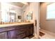 Bathroom featuring dual sinks, dark wood cabinetry, and modern finishes at 2539 Turtle Head Peak Dr, Las Vegas, NV 89135