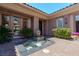 Beautiful front courtyard featuring a tranquil fountain, lush landscaping, and a stylish entrance at 2539 Turtle Head Peak Dr, Las Vegas, NV 89135