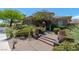 This beautiful home has a well-manicured lawn, lush trees, desert plants, a stone walkway, and exterior lighting at 2539 Turtle Head Peak Dr, Las Vegas, NV 89135