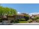 Charming home exterior with a well-maintained lawn, mature trees, and a circular driveway at 2539 Turtle Head Peak Dr, Las Vegas, NV 89135