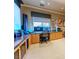 A spacious home office area is equipped with built-in shelving, multiple monitors and windows for natural light at 2539 Turtle Head Peak Dr, Las Vegas, NV 89135