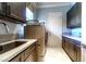 A modern laundry room featuring front load washer and dryer, sink, counter space and dark wood cabinetry at 2539 Turtle Head Peak Dr, Las Vegas, NV 89135