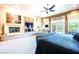 Bright main bedroom with fireplace, media center, and outdoor views at 2539 Turtle Head Peak Dr, Las Vegas, NV 89135