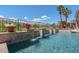 Sparkling pool featuring elegant waterfall features, lush greenery, and palm trees at 2539 Turtle Head Peak Dr, Las Vegas, NV 89135
