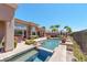 An inviting backyard pool area has a built-in hot tub and is surrounded by lush landscaping and lounge chairs at 2539 Turtle Head Peak Dr, Las Vegas, NV 89135