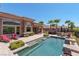This backyard pool is perfect for relaxation and enjoyment, surrounded by landscaped grounds, lounge chairs, and an outdoor grill at 2539 Turtle Head Peak Dr, Las Vegas, NV 89135
