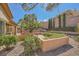 Backyard with decorative gravel landscaping, mature trees, and multiple garden beds at 2601 Deer Lake St, Las Vegas, NV 89134