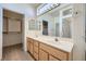 Well-lit bathroom featuring double sinks, a large mirror, and a walk-in closet at 2601 Deer Lake St, Las Vegas, NV 89134