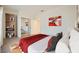 Bedroom featuring a sliding mirrored closet, bookshelves, and red and gray accent pillows at 2601 Deer Lake St, Las Vegas, NV 89134