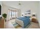 Bright bedroom with ceiling fan, bay windows, and an inviting bed with blue comforter and coordinated decor at 2601 Deer Lake St, Las Vegas, NV 89134