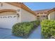 Inviting home entrance with a two-car garage, desert landscaping and trimmed shrubs at 2601 Deer Lake St, Las Vegas, NV 89134