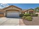 Charming single-story home featuring a two-car garage, desert landscaping, and a welcoming front entrance at 2601 Deer Lake St, Las Vegas, NV 89134