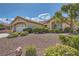 Desert landscaped single-story home featuring native shrubbery and a two-car garage, inviting curb appeal at 2601 Deer Lake St, Las Vegas, NV 89134
