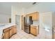 Functional kitchen with stainless steel refrigerator, tile floors, and easy access to other rooms at 2601 Deer Lake St, Las Vegas, NV 89134