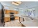 Bright kitchen with stainless steel appliances, tiled flooring, and ample counter space at 2601 Deer Lake St, Las Vegas, NV 89134
