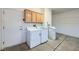 Garage laundry area featuring a washer, dryer, utility sink, and storage at 2601 Deer Lake St, Las Vegas, NV 89134