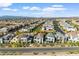 An aerial view of a well-planned community with a clear blue sky, mountain backdrop, and modern home designs at 2710 Marchetti Pl, Henderson, NV 89044